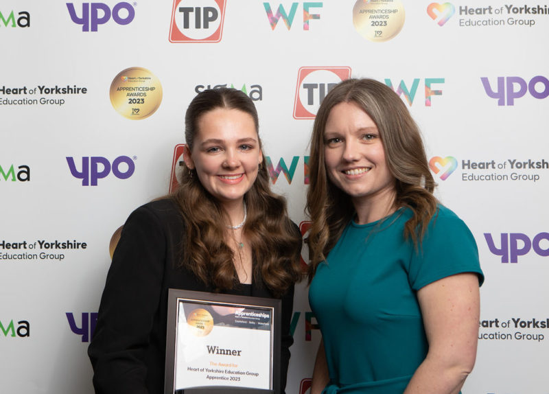 Chloe Smith (left) collecting her award from Justine Wood, Head of Apprenticeships Quality and Curriculum at the Heart of Yorkshire Education Group