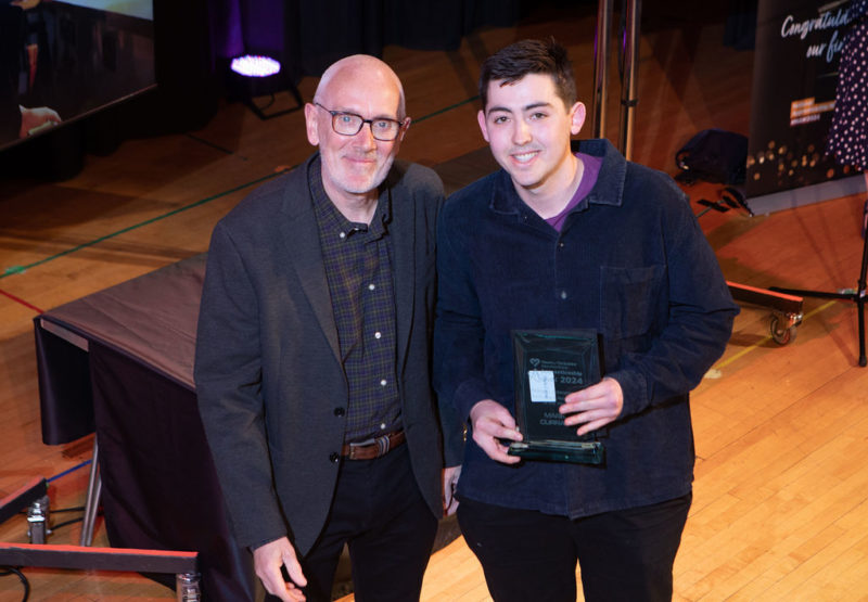 ﻿﻿Andrew McConnell OBE (left) presenting Mark Curran with the Business, Enterprise & Professional Apprentice of the Year award (right)