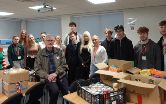 Nigel Currey Chairman of Trustees at Selby District Food Bank with students
